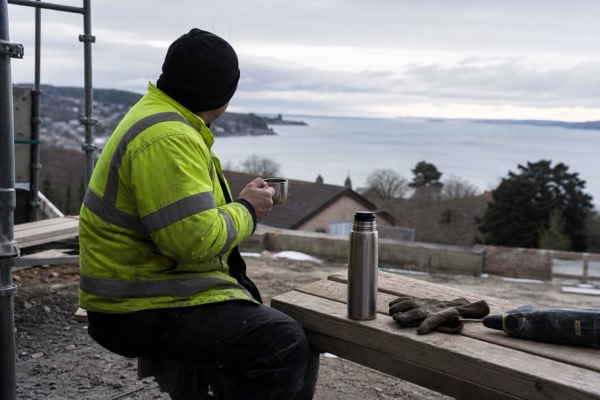 Tradesperson taking a calm tea break on site after finishing work
